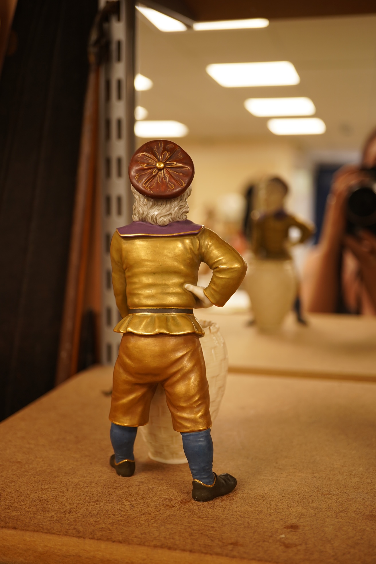 A late 19th century Royal Worcester figure of a boy with basket, 17.5cm high